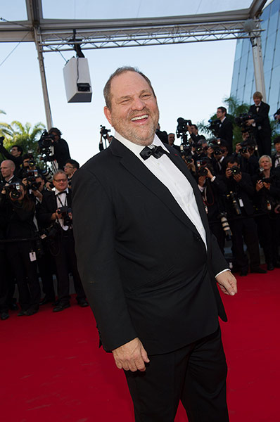 Moonrise: A jolly Harvey Weinstein jokes with photographers