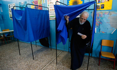 Father Christos exits a voting booth at an Athens primary school on 17 June