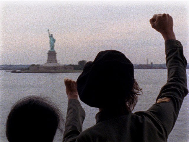 Yoko Ono archive photos: Lennon and Yoko Ono raising their fists to The Statue of Liberty 