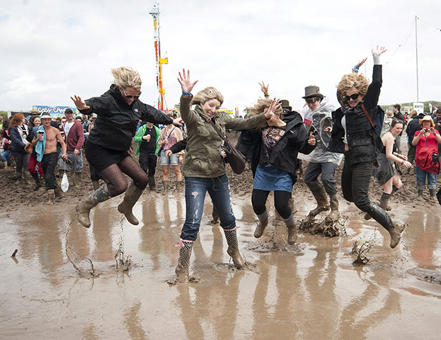 ISle of Woght: Festival-goers splash in the mud