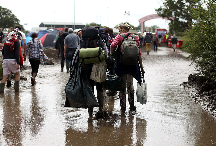 week in music: Festival-goers arrive at a muddy Isle of Wight festival site on 22 June