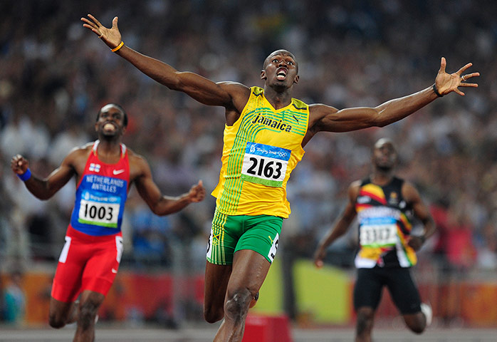 Usain Bolt: Usain Bolt of Jamaica realises he has won the race 