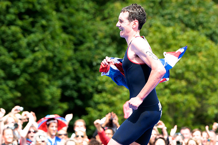 team GB celebrations: Gold medal-winning triathlete Alistair Brownlee runs with the flag