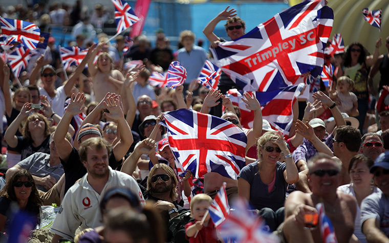 team GB celebrations: Crowds  on the Weymouth beach cheer as they watch Ben Ainslie