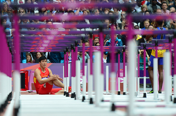 Olympic pain: China's Liu Xiang reacts after falling in the men's 110m hurdles heats