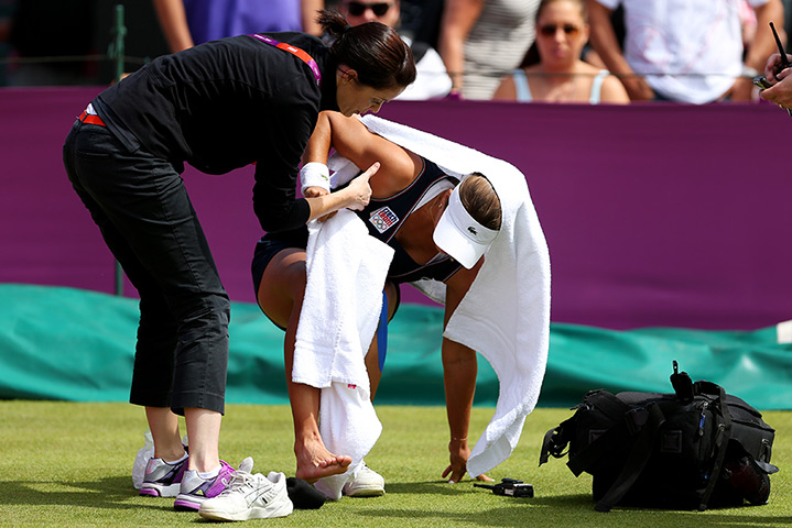 Olympic pain: Petra Cetkovska of Czech Republic is helped to her feet
