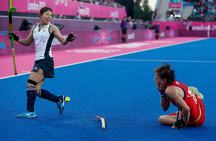 Olympic pain: Britain's Kate Walsh falls onto the pitch after getting hit in the face 