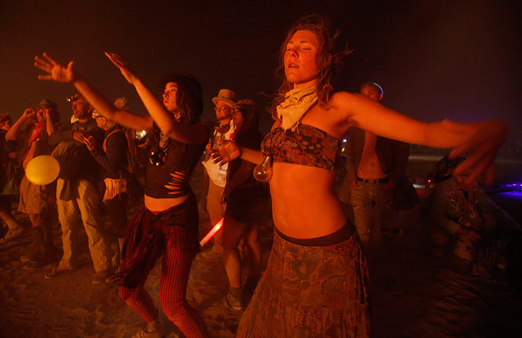 Burning Man: Sophie Keel and Emilyne Love dance around the burned remains of the Anubis