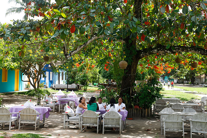 Brazil beaches: People sitting in a restaurant at Quadrado, Trancoso, Bahia.