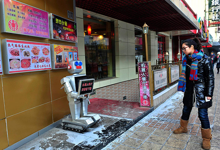 Robot Restaurant: A robot greets people outside a Restaurant
