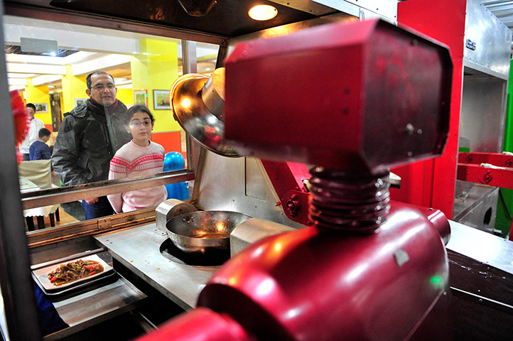 Robot Restaurant: Customers watch a robot cooking dishes at a Robot Restaurant in Harbin