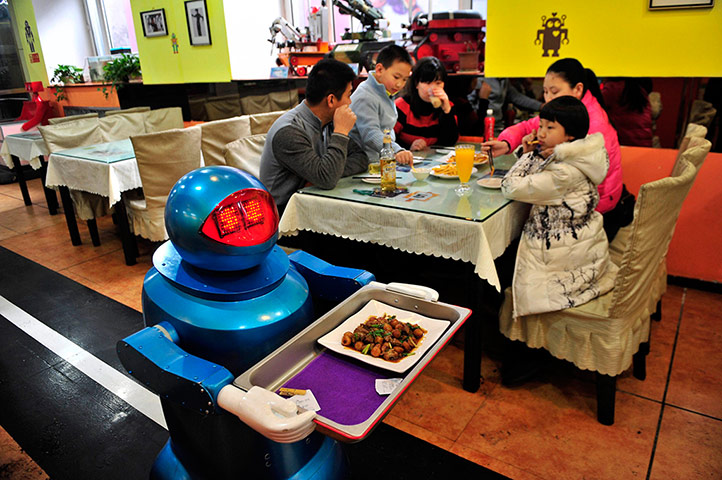 Robot Restaurant: Robot delivers a dish to customers at a Robot Restaurant in Harbin