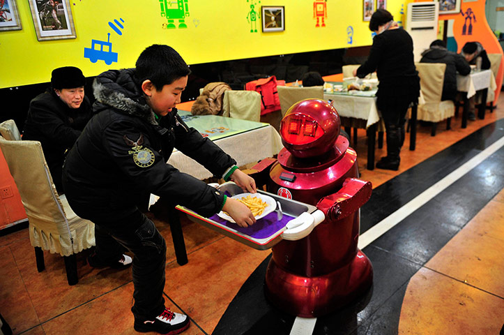 Robot Restaurant: A robot serves a customer with French fries