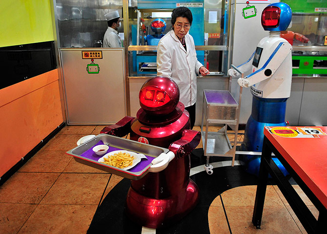 Robot Restaurant: Robot delivers French fries to customers at a Robot Restaurant in Harbin