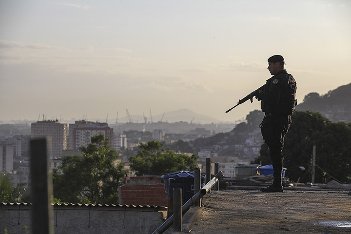 Favela clearance: An armed soldier takes position in the favela, as part of a policing progra