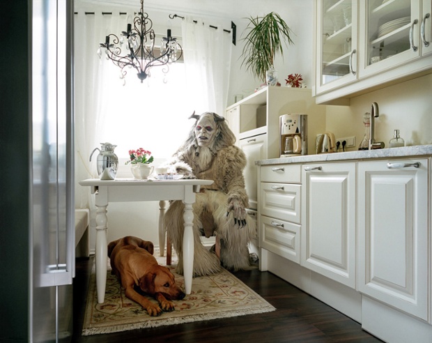 A festive white 'percht' stops for a quiet cup of tea in the kitchen. Perchten come in two types: the 'beautiful' and the 'ugly'. The beautiful are believed to bring luck and wealth, but the ugly are also good omens, scaring away malicious ghosts and demons. This is an ugly one. And the thing under the table is a dog and not a furry. We’re 99% sure on that one.