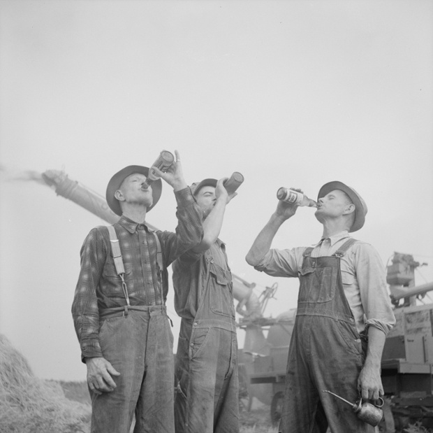 Three farmers break into a bottle of Old Milwaukee, a brand of dry lager, 1941