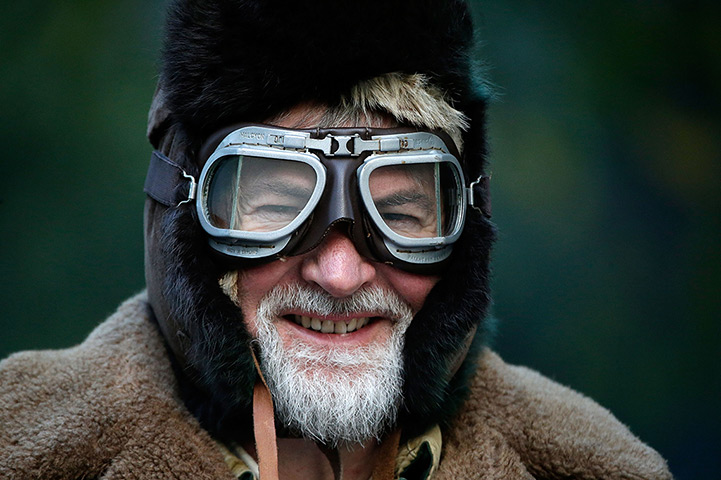 London-Brighton car rally: A classic car enthusiast wraps up against the cold