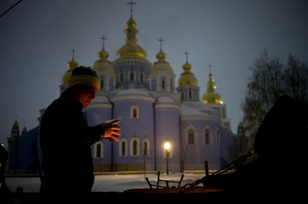 A pro-European Union activist drinks tea to warm himself near a bonfire in a monastery in Kiev, Ukraine.