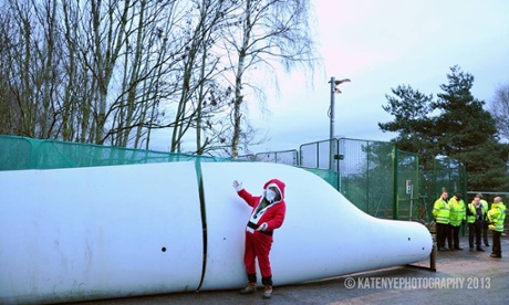 Protester dressed as Santa next to wind turbine placed by activists at Barton Moss drilling site operated by IGas