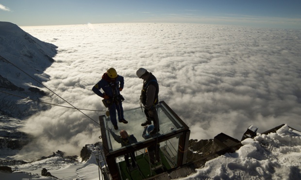 Workers stand on top of the 