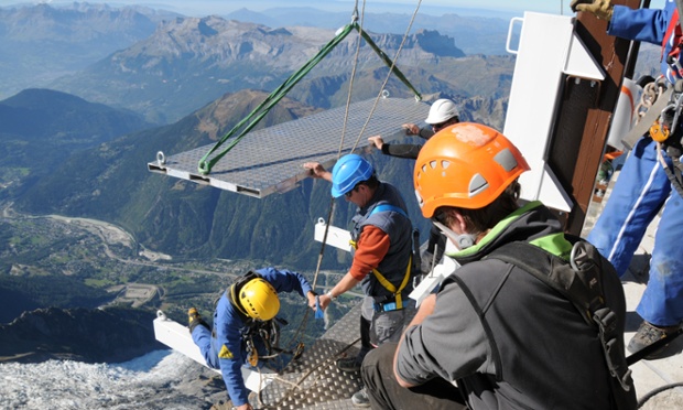 Workers putting together the platform for the skywalk. Construction jobs don't come more terrifying than this.