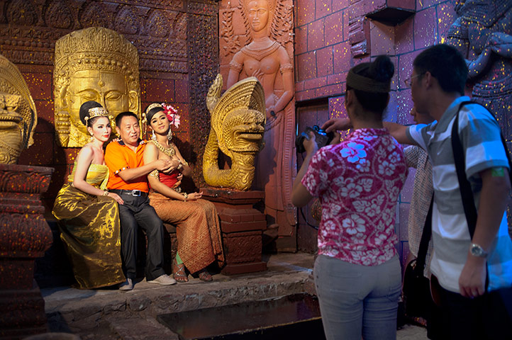 Chinese tourists: A Chinese tourist poses with two ladyboys