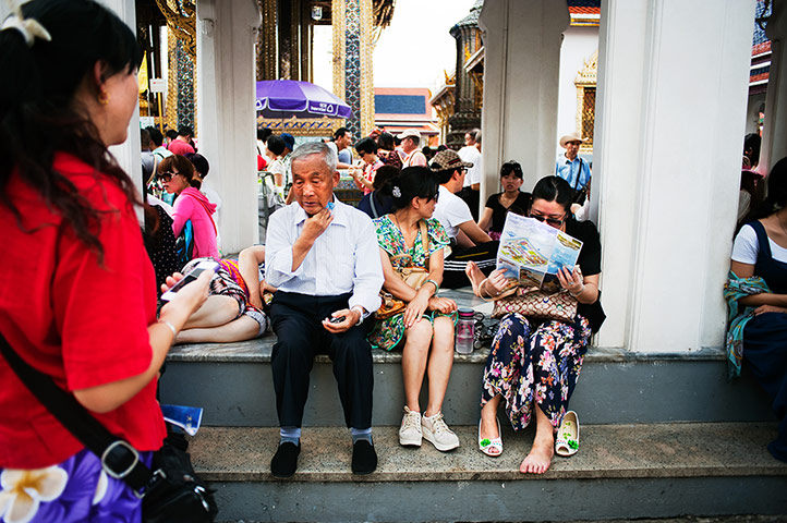 Chinese on tour: Chinese tourists rest under the pavilion