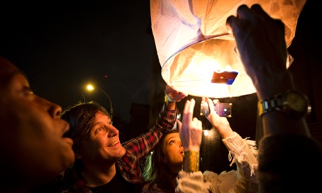 People release paper lanterns after lighting them outside Madiba, a restaurant named in honor of former South African President Nelson Mandela, in the Brooklyn borough of New York