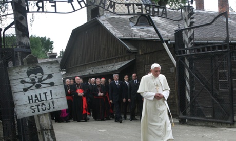 FILE - In this May 28, 2006 file photo, Pope Benedict XVI walks through the gate of the former Nazi concentration camp Auschwitz in Oswiecim, Poland, to pay his respects to the Holocaust victims. Sign at left reads 