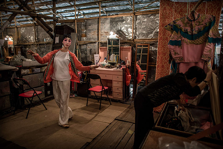 Cantonese opera: An actress rehearses backstage in the temporary theatre