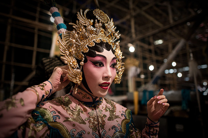 Cantonese opera: An actress adjusts her hat