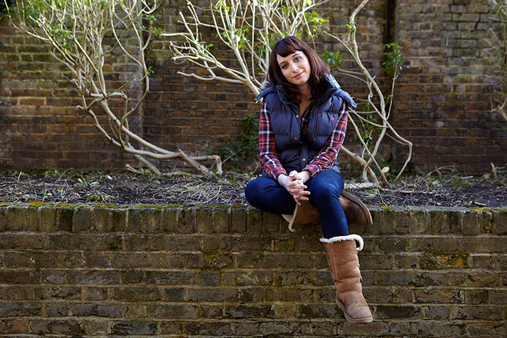 IsySuttieCoastal: Comedian Isy Suttie sitting on a wall