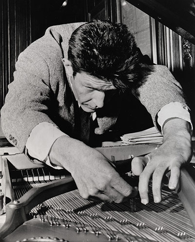 Barbican: John Cage preparing a piano, c.1964