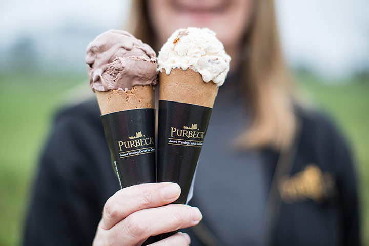 MarkHixDorset: A woman holding up two cones of Purbeck ice cream