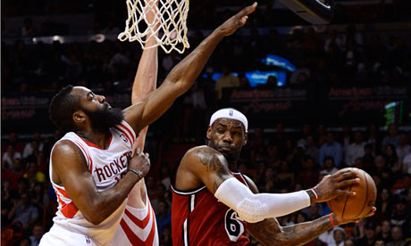 Miami Heat's LeBron James is defended by Houston Rockets' James Harden