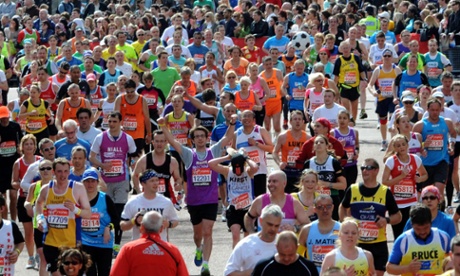 Competitors head to the finish line during the 32nd Virgin London Marathon in London.