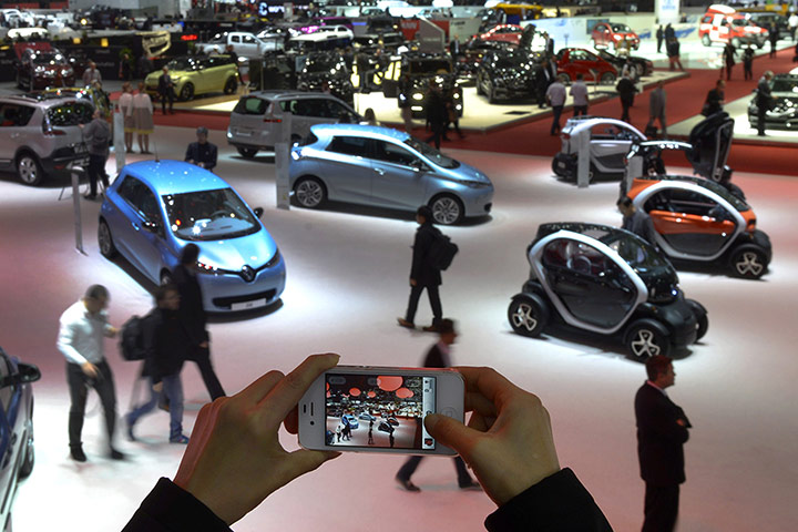 Geneva motor show: A person takes a picture of cars on Marc