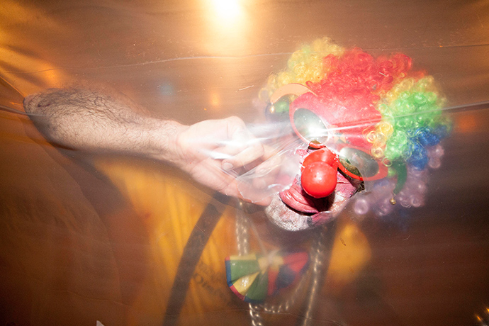 Adelaide Festival day nine: A clown pokes his head through plastic