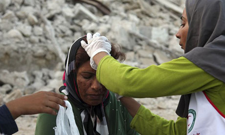 An Iranian woman receives medical treatment after an earthquake struck the country's south