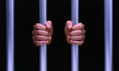 Mans-hands-on-prison-bars-008.jpg