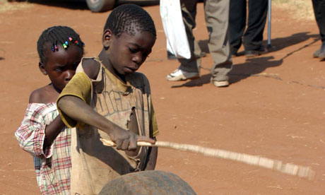 A Zambian boy plays with a used tyre in Livingstone