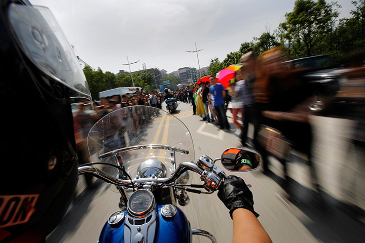 Harley rally: Spectators line the streets to watch the rally