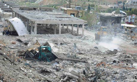 Handout photo showing damage what appears a chicken farm following an air strike near Damascus