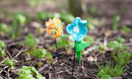 knitted flowers planted in the ground