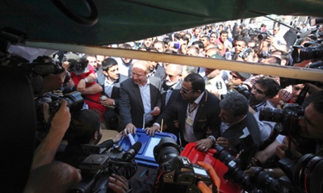 Mohammad Bagher Qalibaf, centre left, casts his ballot in the presidential election