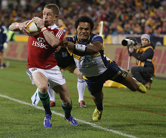 Lions: Shane Williams of the Lions is tackled by Henry Speight