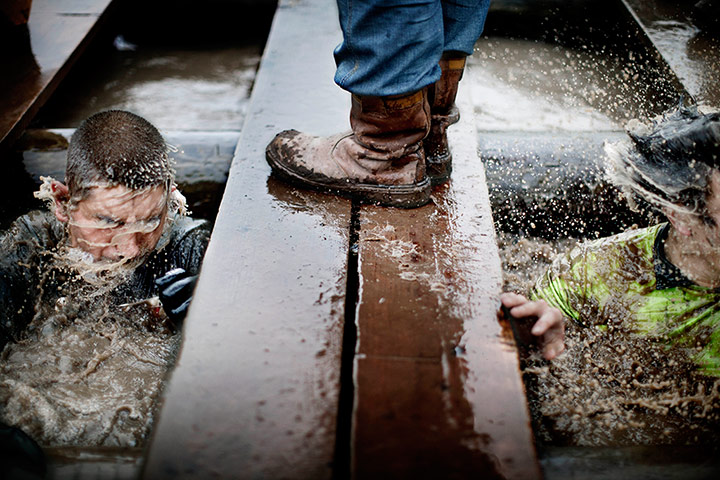 Tough Guy - Weekend: image showing man's feet in boots standing on some wet planks