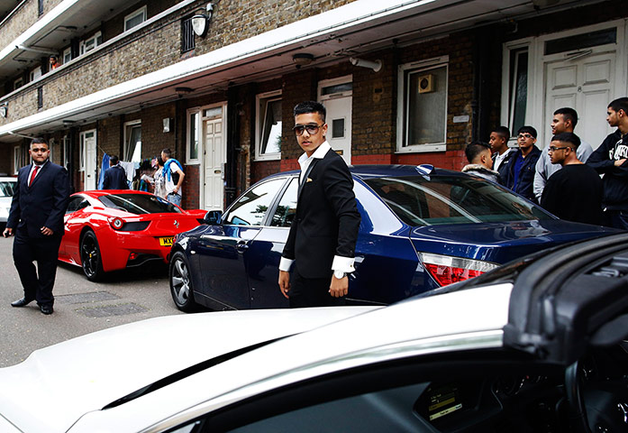 Supercar parade: Reyaz Rahman, 16, walks past a parade of 