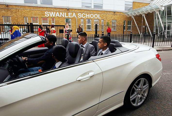Supercar parade: The students drive past their school on their graduation day
